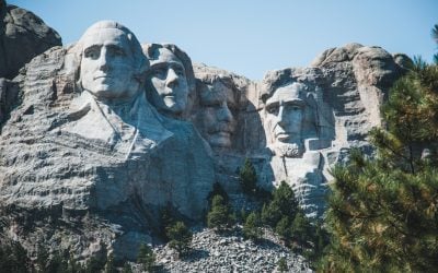 Iconic view of Mount Rushmore with presidential sculptures on a sunny day.